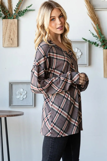 Woman wearing Heimish plaid exposed seam V-neck t-shirt with long sleeves and casual fit in a bright room setting