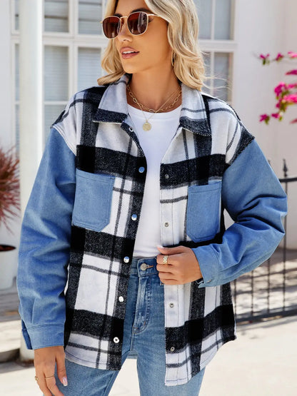 Woman wearing pocketed plaid snap down denim jacket with black and white pattern and blue sleeves outdoors
