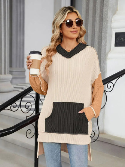 Woman wearing a double take contrast hooded long sleeve top with kangaroo pocket holding a coffee cup outdoors